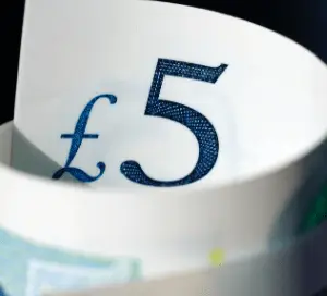 Rolled up five pound note in England