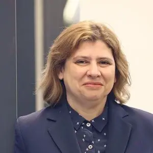 Woman in a blue outfit posing for a corporate photo