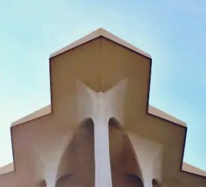 View of a beige building and blue sky